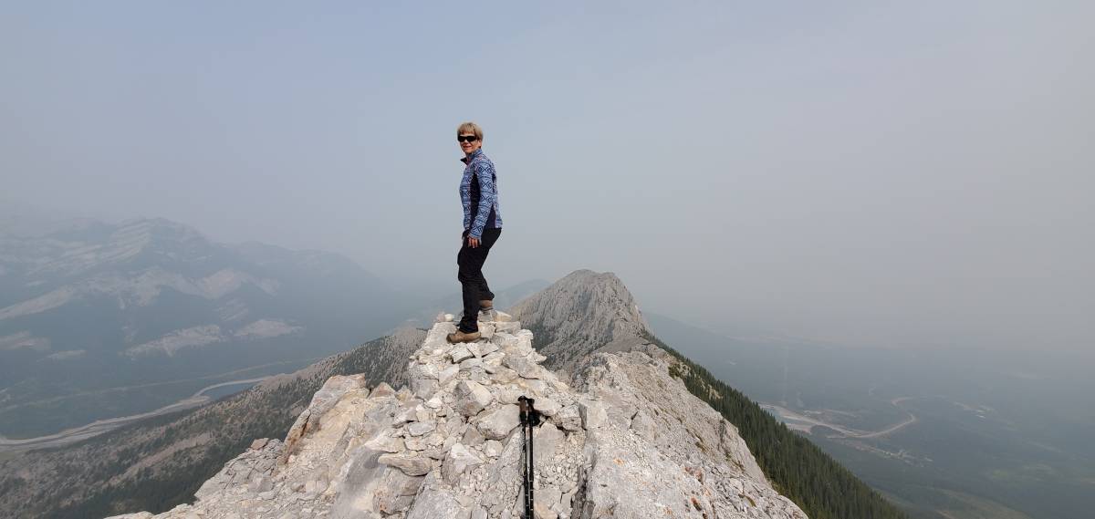 friend summiting Baldy Peak on a smokey day