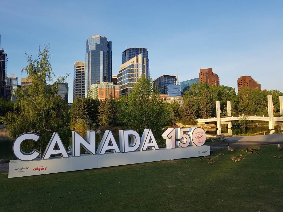 Downtown Calgary with Canada 150 sign on Princes Island